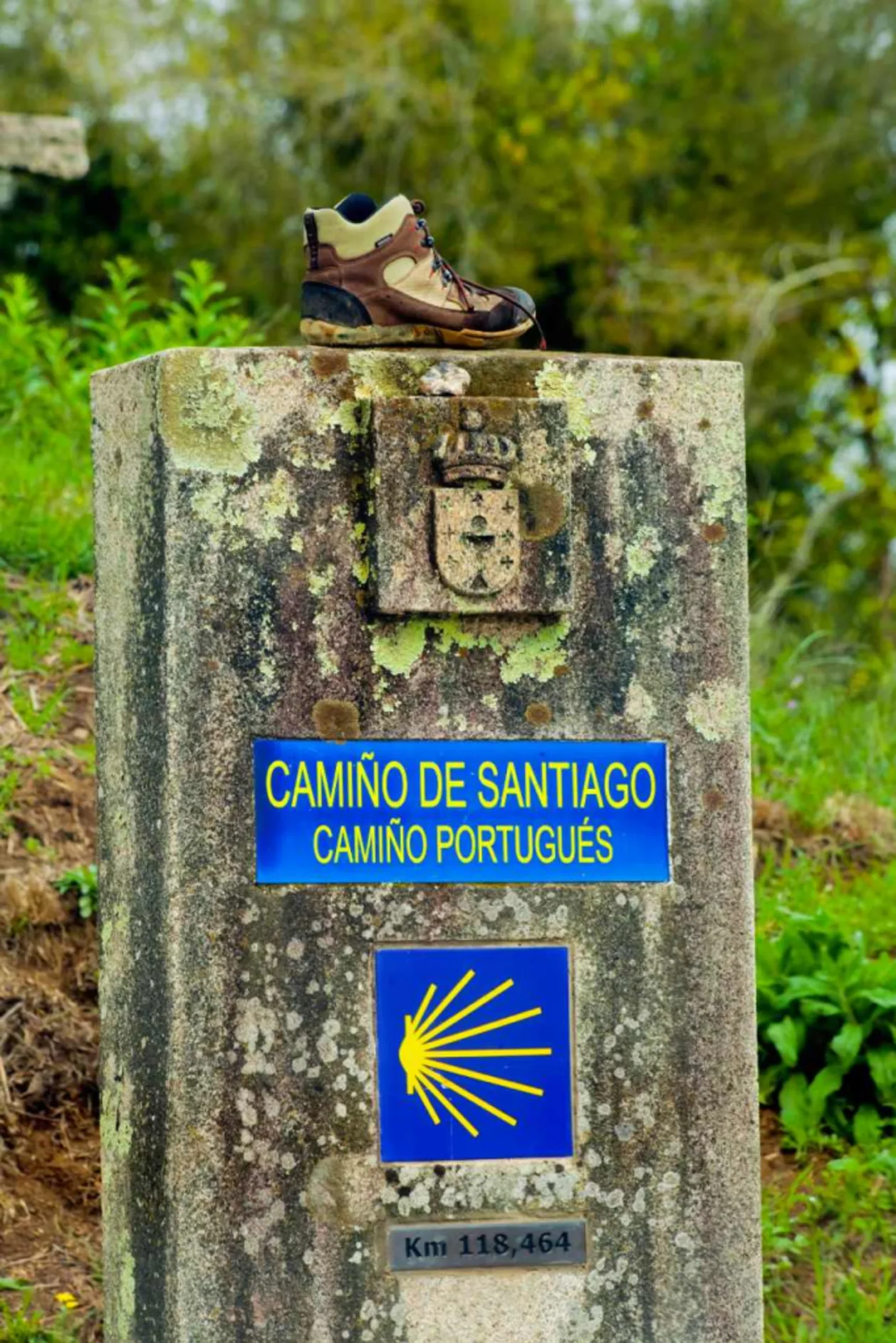 Camino de Santiago sign, scallop symbol, hiking boot on top